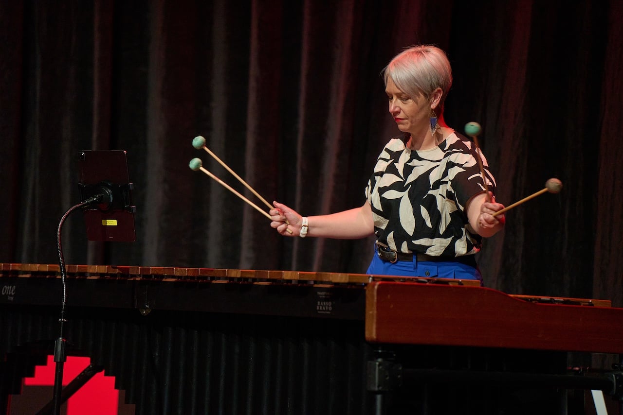 Performer playing a marimba on stage